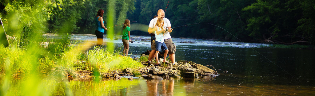 family fishing in a river